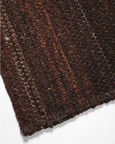 a close up view of a brown and black rug