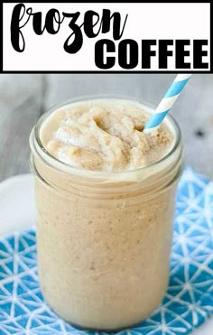 a mason jar filled with coffee on top of a blue and white table cloth next to a