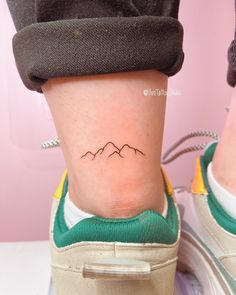 a person with a small tattoo on their leg