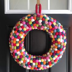 a colorful wreath hanging on the front door