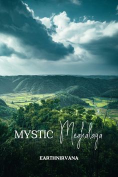 the cover of mystic megaalaya by earthinrvana, featuring green hills and clouds