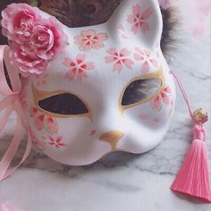 a white mask with pink flowers on it