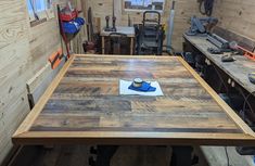 a wooden table in a workshop with tools on it