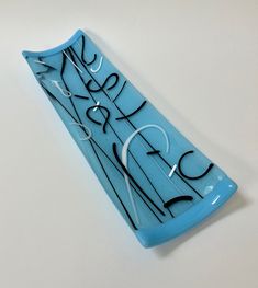 a blue glass vase with writing on it