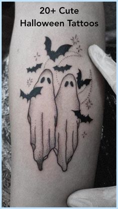 two ghost tattoos on the thigh with bats coming out of their mouths and flying through the air