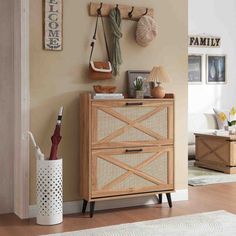 a wooden cabinet sitting in the corner of a living room next to a white rug