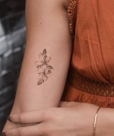 a woman with a flower tattoo on her arm