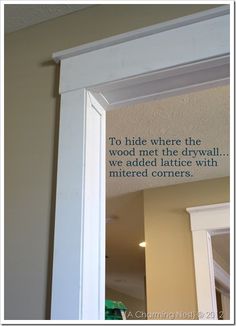 a white framed mirror with a quote on the wall above it that reads to hide where the wood met the drywall we added lattice with material