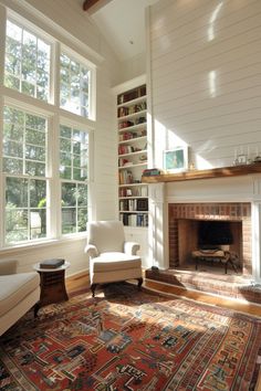 a living room filled with furniture and a fire place in front of a large window