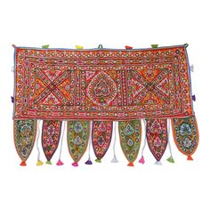 an embroidered table runner with tassels and fringes on the edges, in multicolor