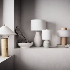 a shelf with various lamps and vases on it