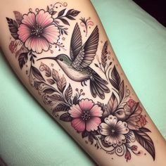 a hummingbird with flowers and leaves on the arm tattoo design for women's leg