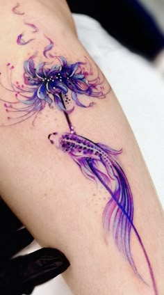 a woman's arm with a tattoo on it and a flower in the middle