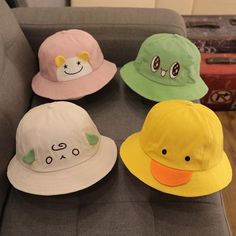 four hats sitting on top of a couch