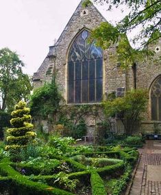 an old church with a garden in the foreground