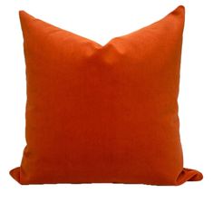 an orange pillow on a white background