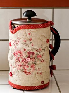 a coffee pot cover with flowers on it