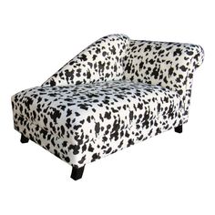 a black and white spotted couch sitting in front of a white background