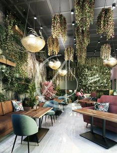 the interior of a restaurant with plants hanging from the ceiling and wooden tables in front of them