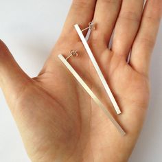 This geometry minimalist pair of sterling silver earrings is made from sterling silver wire 925 3mm. Are totally handmade and there is no use of mold. MATERIALS: sterling silver 925 3mm rectangular wire DIMENSIONS:7 x 0,3 cm (2 3/4 inch x 3/32 inch) approximately Every pair is handmade and unique. You will receive a very similar to the photo but not identical. I can make them in different length If you want.You just have to convo me. I will pack your earrings in a gift box as in my last photo an Geometrical Earrings, Architectural Earrings, Handmade Wedding Band, Silver Bar Earrings, Rectangular Earrings, Contemporary Earrings, Minimalist Contemporary, Silver Bar, Statement Ring Silver