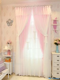 a bedroom with pink curtains and white furniture