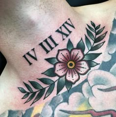 a man with tattoos on his chest has a flower and the words in roman numerals