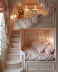 two bunk beds with pink pillows on them and some stairs leading up to the top