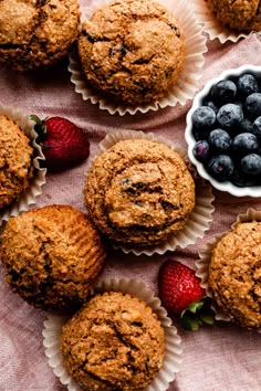 muffins with blueberries and strawberries on a table