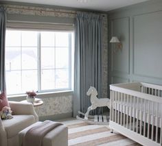 a baby's room with a rocking horse in the corner