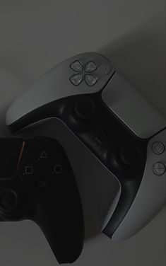 two video game controllers sitting next to each other