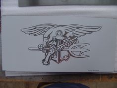 a drawing of an eagle holding a wrench on top of a piece of paper