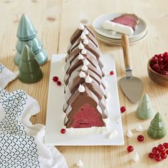 there is a cake that has been cut into pieces and placed on the table with other decorations around it