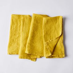 three yellow towels folded on top of each other