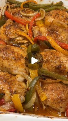 chicken with peppers and onions in a white casserole dish