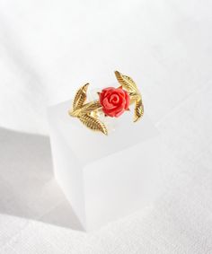 14K Gold Plated Red Rose Adjustable Ring Inspired by the fairytale Beauty and the Beast, this ring features a red rose gracefully wrapping your finger. It is elegantly designed with a simple gold-plated band adorned with leaves, radiating a minimalist and romantic style that will enhance the charm of all your outfits. Suitable for both casual and formal occasions, this magical ring can be worn day or night, making it a perfect gift for your loved one or a delightful treat for yourself! Details: * Material: 925 Sterling Silver plated with 14K Gold. * No sizes, it is adjustable! Best for US sizes 6 to 12. Packaging: You will get your jewelry in a beautiful pink Pharos Jewellery box. This box will protect your precious item during the shipping process. It is also great for storing your item a Luxury Red Elegant Flower Ring, Red Flower Shaped Rings As Gift, Red Flower-shaped Rings As Gifts, Elegant Red Flower-shaped Jewelry, Unique Red Flower-shaped Jewelry, Princess Belle, Rose Rouge, Open Ring, Romantic Style