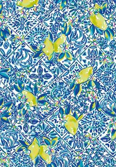 a blue and yellow wallpaper with lemons on the top, in an ornate pattern