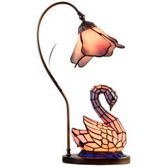 a lamp that is on top of a stand with a swan on it's body