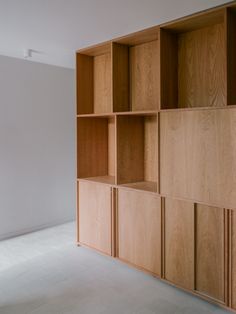 an empty room with wooden shelves on the wall