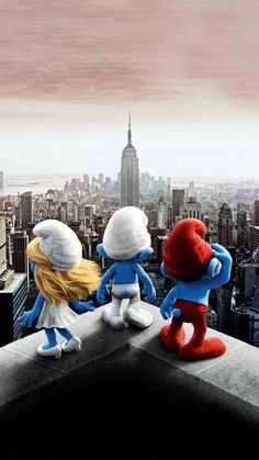 the smurfs are standing on top of a building looking out at the city