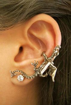 a close up of a person's ear with an animal design on the side