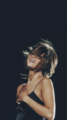 a woman with her hair blowing in the wind