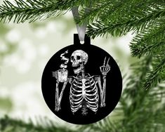 a christmas ornament with a skeleton holding a knife and fork