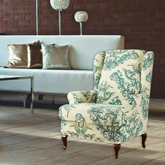 a living room filled with furniture and pillows on top of it's wooden floors