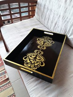 a black and gold tray sitting on top of a bed