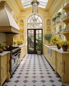 a kitchen with yellow cabinets and black and white checkered flooring on the walls