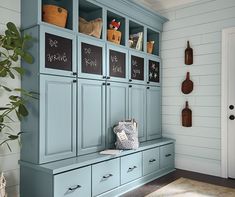 a room with blue cabinets and chalkboard on the wall