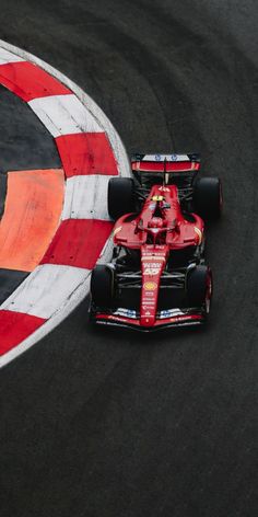 two racing cars driving on a track with red and white stripes around the edges, in front of each other