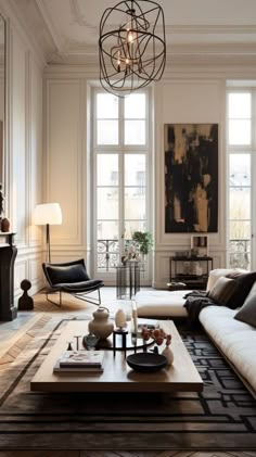 a living room filled with furniture and large windows