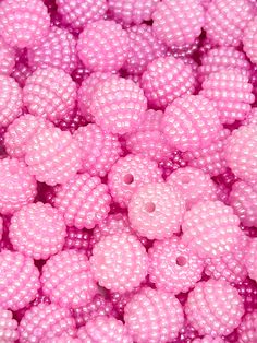 many pink beads are stacked together in a pile