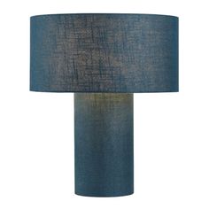 a blue table lamp with a black shade on the base and a white back ground